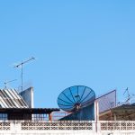 satellite-dish-television-antenna-old-building-with-blue-sky-background-morning